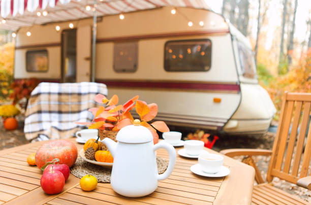 Table and chairs outside trailer in nature
