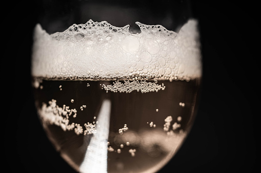 Close-up of a glass with beer on a black background