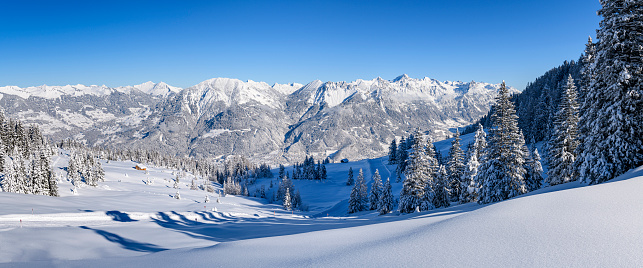 Panorama of a snowy winter landscape with perfect conditions for skiing in ski resort. Photographed in Brandnertal, Vorarlberg, Austria.