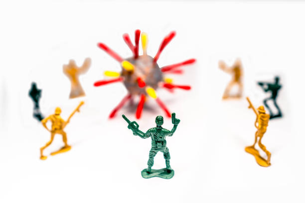 Toy army men attack and fight off the coronavirus as metaphor for human immune system