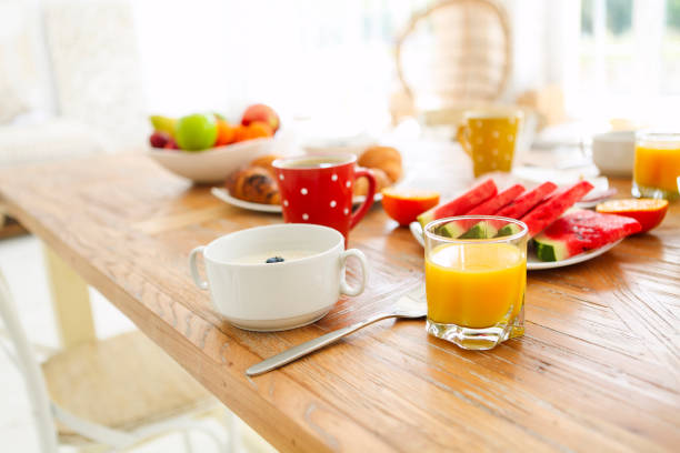 istock Coffee with fruit, cereal and croissant on wooden table background 1299620658