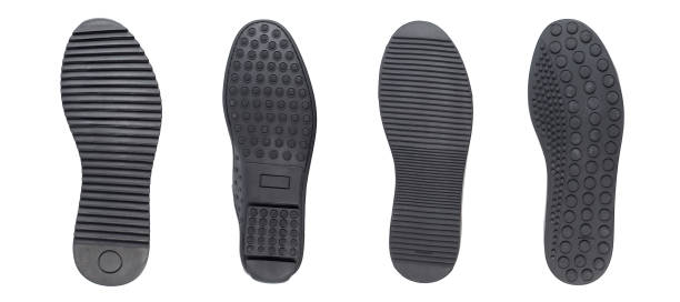 istock Four black shoe sole in row. Whole background. 1299625373