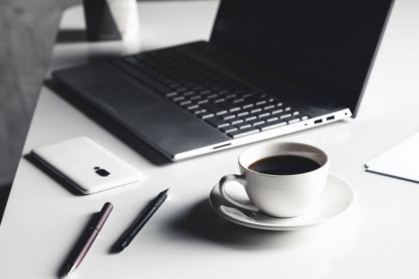 istock Business man using laptop computer with pen glasses and cup of hot coffee 1299625430