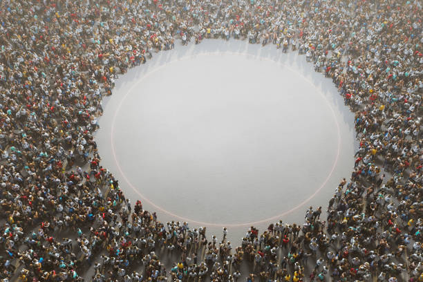 istock Large group of people around empty area 1299625510