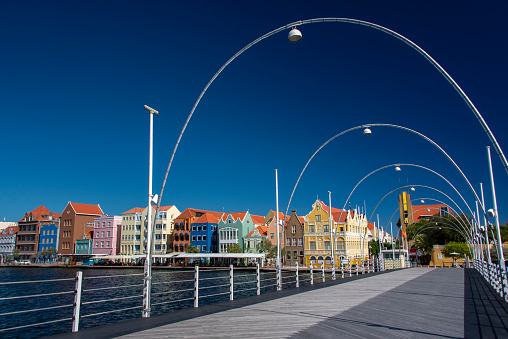 Colourful historic facades on the Handelskade in Willemstad, seen from the Queen Emma pontoon bridge.