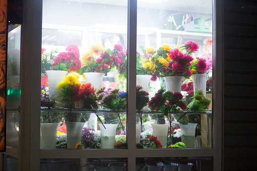 Selling flowers in the night. Flower shop in the city at night.