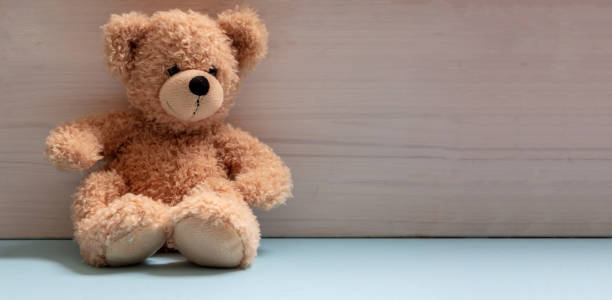 istock Teddy bear sitting on blue floor, child room, nursery 1299632103