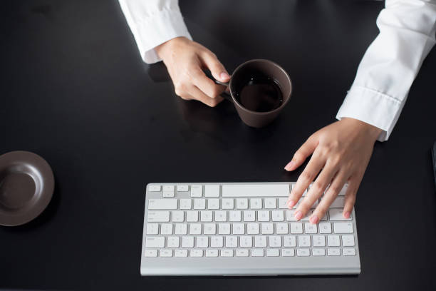 istock Close up. Woman office worker typing on the keyboard on desk office. 1299632432