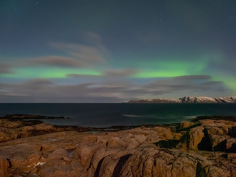 Evening polar landscape with the Aurora Borealis.