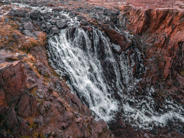 istock A frozen waterfall with ice. Winter background. 1299632601