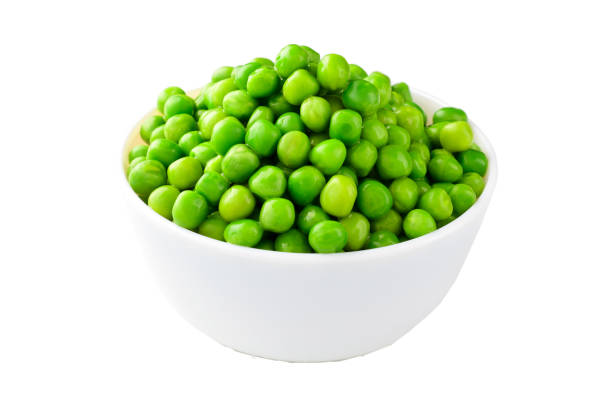 istock Green peas in bowl isolated on white background with clipping path 1299633387