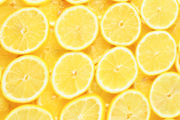 istock A slices of fresh juicy yellow lemons.  Texture background, pattern. 1299633544