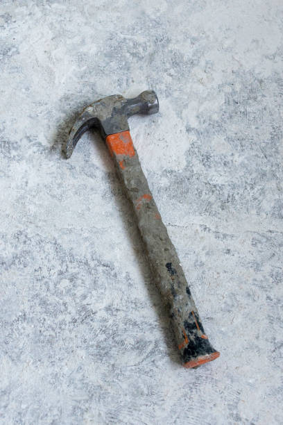 istock Shabby hammer on dusty concrete floor 1299633862