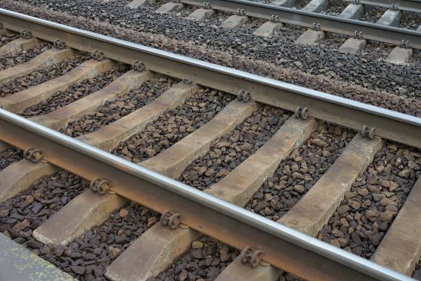 part on rails and sleepers in gray stones and rubble part on rails and sleepers in gray stones and rubble on the railroad railroad track concrete railway sleeper thoroughfare stock pictures, royalty-free photos & images