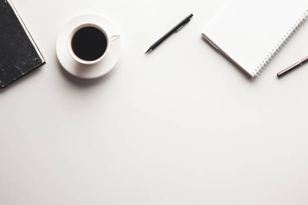 istock Office desk table with supplies, coffee cup and flower. Top view 1299634831