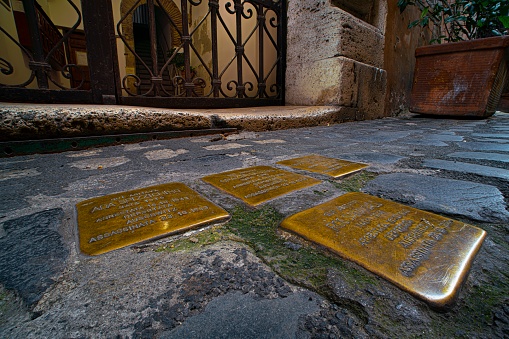 Rome, Italy - december 19, 2020: Stolpersteine in Jewish ghetto, in Rome, Italy. Brass cobblestones mark the places where individual Holocaust victims