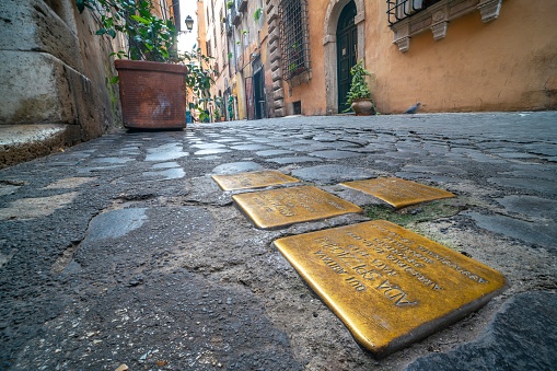 Rome, Italy - december 19, 2020: Stolpersteine in Jewish ghetto, in Rome, Italy. Brass cobblestones mark the places where individual Holocaust victims