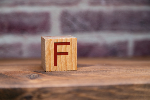 Letter F written on wooden blocks.