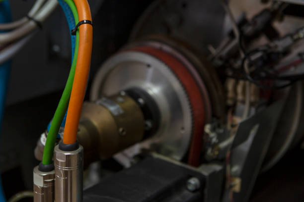 istock Electric cords pugged into machine, orange, blue and green 1299638342