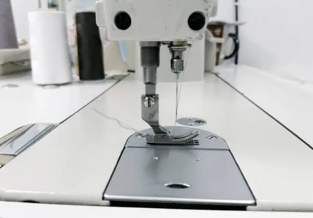 foot and needle of industrial straight-line sewing machine side view.