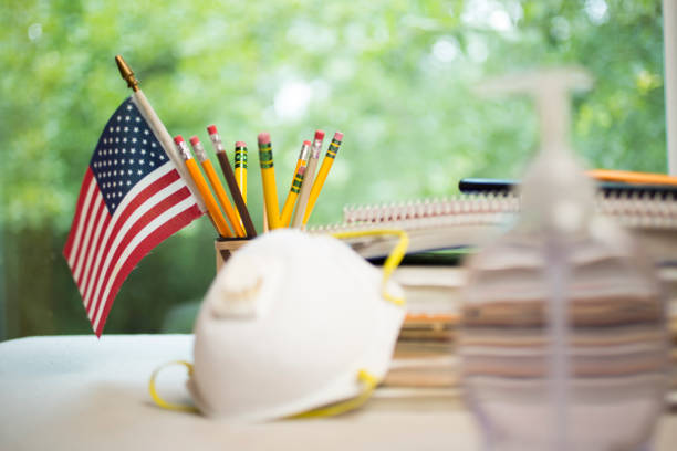 istock Stack of Books on Desk in front of window. 1299643737