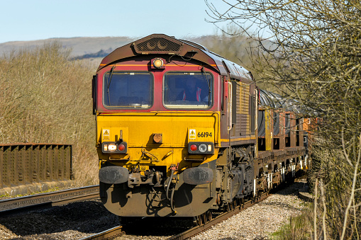Cardiff, Wales - April 2018: Close up of a heavy freight locomotive pulling wagons. The train is operated by the English Welsh and Scottish Railway Company