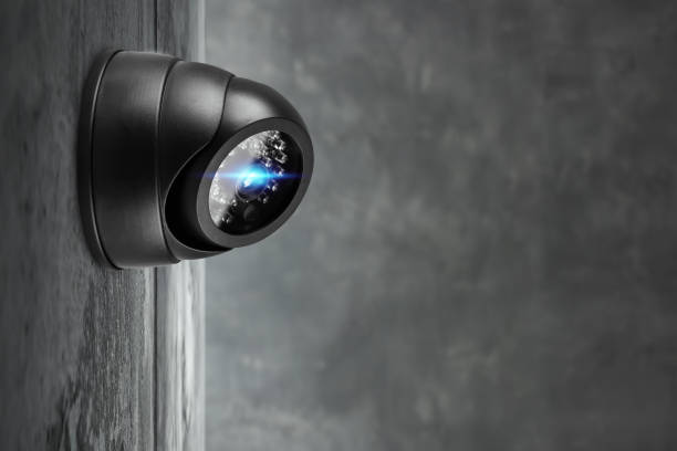 istock Smart CCTV camera on the wall with blue lights. Cameras work day and night, video recording in the dark. Protection from thieves and vandals. 1299644975