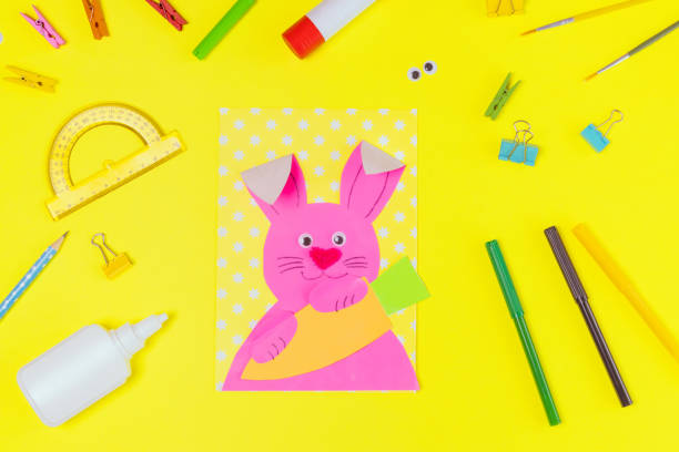 istock DIY and kids creativity. Step by step instruction: Create an Easter card with bunny and carrot. Childrens handmade Easter craft. 1299645050