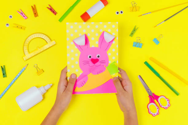 istock DIY and kids creativity. Step by step instruction: Create an Easter card with bunny and carrot. Childrens handmade Easter craft. 1299645060