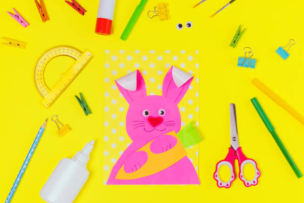 istock DIY and kids creativity. Step by step instruction: Create an Easter card with bunny and carrot. Childrens handmade Easter craft. 1299645064