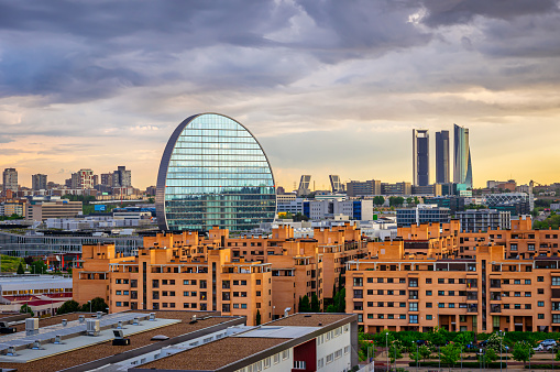 Financial district in Madrid with 4 Torres, Kio towers and La Vela (BBVA city) at sunset from Las Tablas quarter, Spain