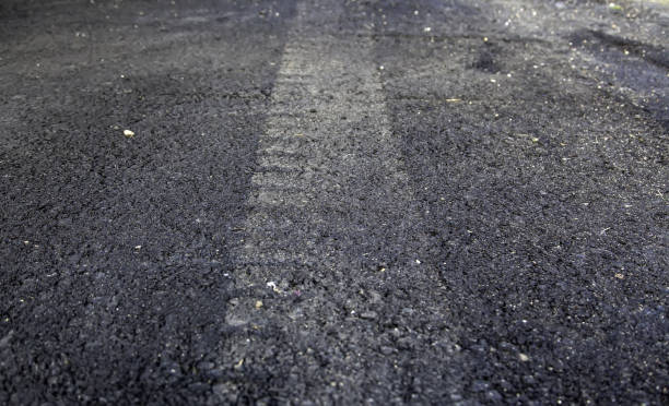 istock Wheel tracks on street 1299646966