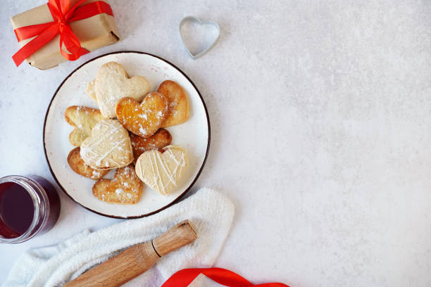 istock Valentines day heart shaped cookies and gift box on gray table with copy space 1299647759