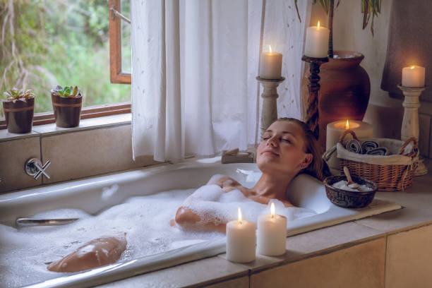 Beautiful Woman Lying Down in the Bath Beautiful Woman with Pleasure Lying Down in the Bath With Foam. Enjoying Weekend at Spa Hotel. Pampering Day. bath salt stock pictures, royalty-free photos & images