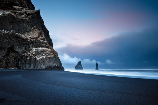 Beautiful Landscape of a Black Pebbles Beach Beautiful Landscape of a Famous Black Pebbles Beach. Amazing View on the Basalt Cliffs in the Sea. Vik Myrdal. Iceland black sand stock pictures, royalty-free photos & images