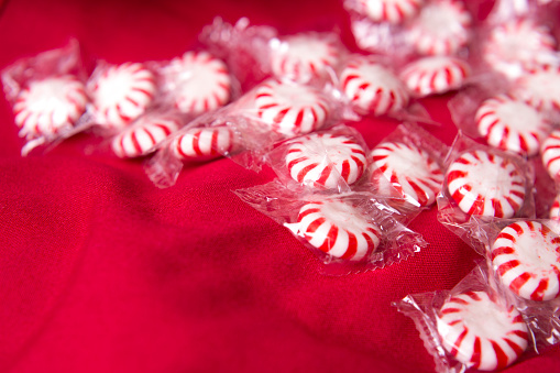 Valentine's Day Concept - Red and White Candy in wrapper.\nCandy on red background with plenty of room for your copy text.\nSee our similar candy images without the wrappers.