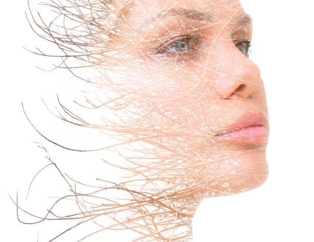 istock A confident young woman's double exposure portrait close up combined with bare tree branches against white bakcground 1299654956