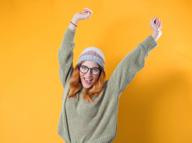 istock Cheerful smiling young woman with arms raised, isolated on white background 1299655463