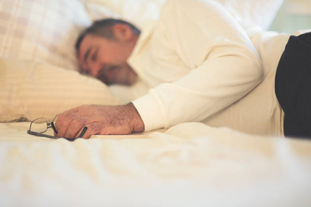 istock Attractive man is taking nap on the bed. 1299657506