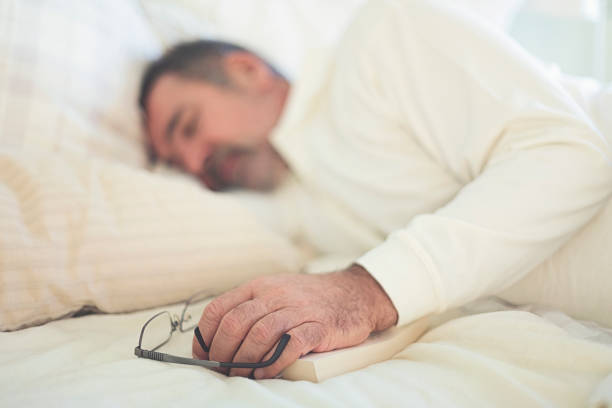 istock Attractive man is taking nap on the bed. 1299657565