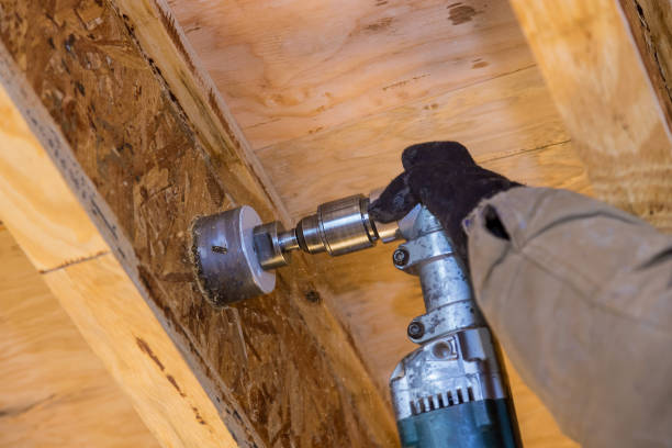 istock Pumping contractor for drilling hole in joist for ABS and PVC drain pipe 1299658711