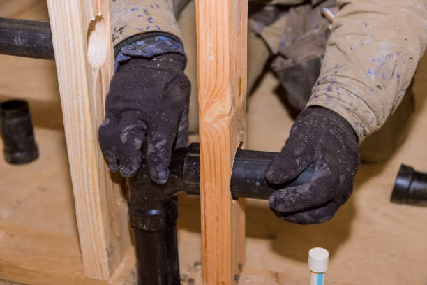 istock Plumbing contractor installing PVC plastic drain pipe in the section for custom house 1299658742