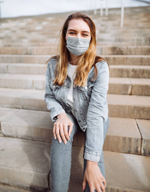 istock woman with face mask portrait 1299658861