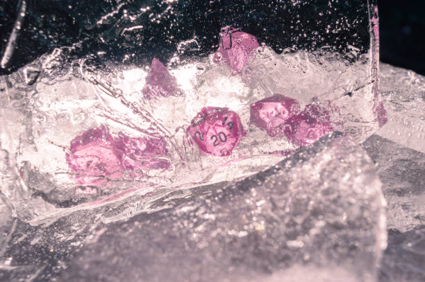 Set of dice behind a sheet of ice in the sunlight stock photo