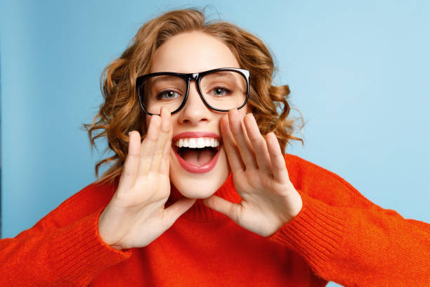 istock Excited young woman making announcement 1299662174