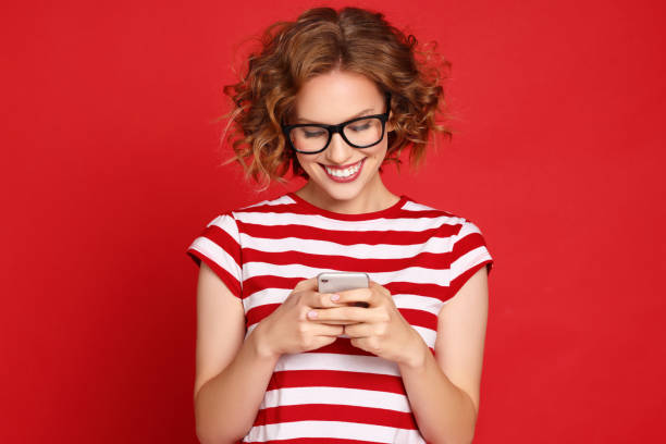 Happy woman reading message on smartphone