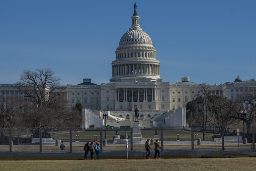 Washington D.C., January 30, 2021:  Fences were erected around Capitol after January 6 when pro-Trump protesters rallied in DC ahead of Electoral College vote count and some stormed into the Capitol. Visitors have to stay outside the fence to view the Capitol.