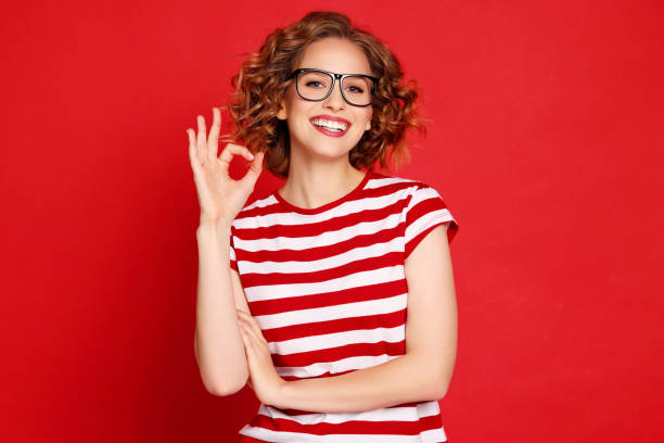 istock Delighted young woman gesturing OK 1299663216