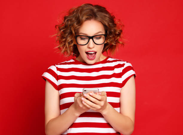 istock Surprised woman reading message on smartphone 1299663268