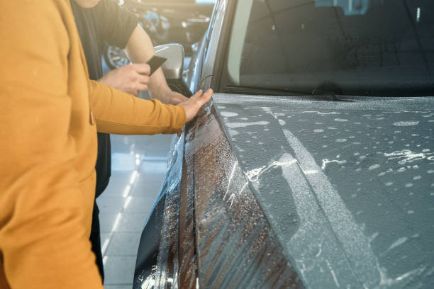 istock Installing PPF or Paint Protection Film on car as protective polymer skin from scratches and rock chips 1299663633